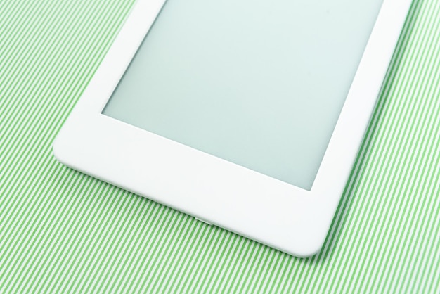 Ebook reader over green striped background