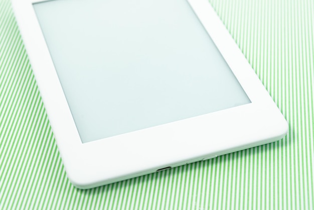 Ebook reader over green striped background