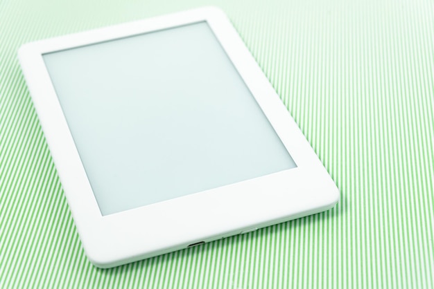 Ebook reader over green striped background