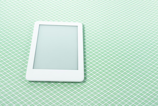 Ebook reader over green striped background