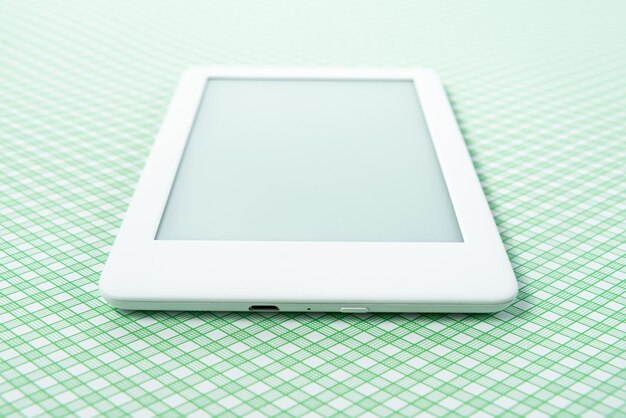 Ebook reader over green striped background