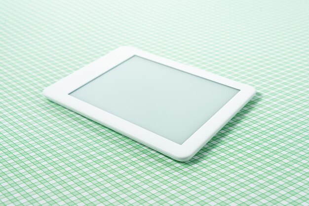 Ebook reader over green striped background