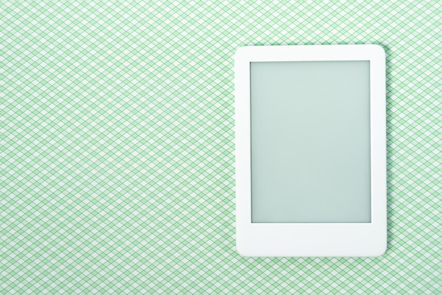 Ebook reader over green striped background