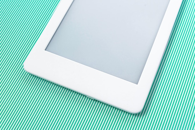 Ebook reader over green striped background