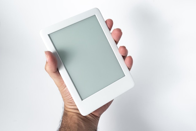 Ebook reader over isolated white background  being held by a male hand