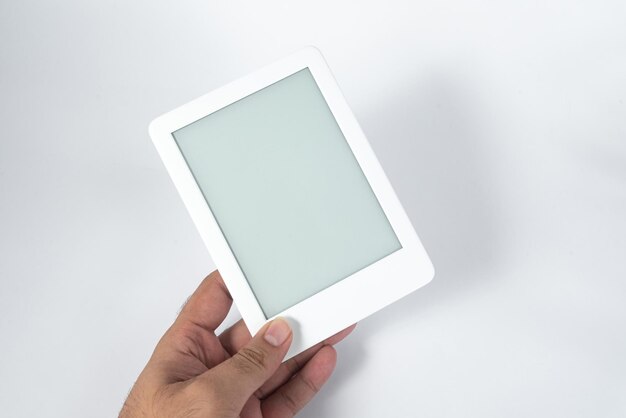 Ebook reader over isolated white background  being held by a male hand