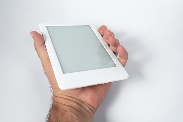 Free photo ebook reader over isolated white background  being held by a male hand