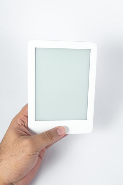 Ebook reader over isolated white background  being held by a male hand