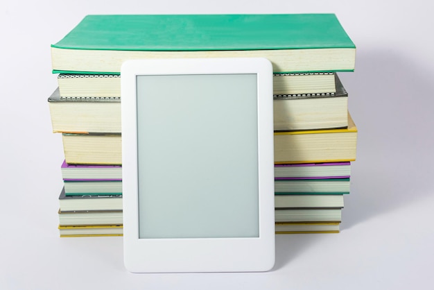 Free photo ebook reader next to paper books