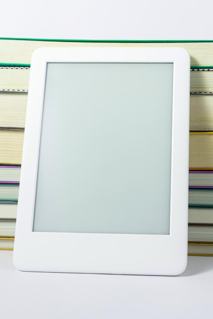 Free photo ebook reader next to paper books