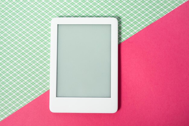 Ebook reader on the striped green background with pink