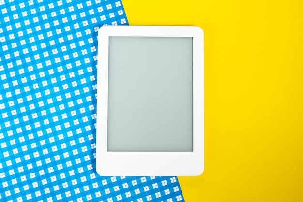 Free photo ebook reader over yellow and blue background