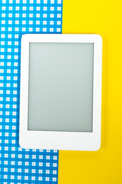 Ebook reader over yellow and blue background