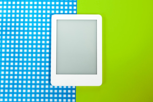 Ebook reader over yellow and blue background