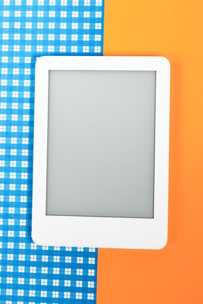 Ebook reader over yellow and blue background