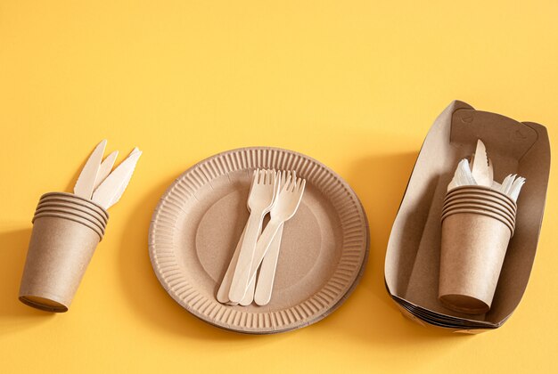 eco friendly disposable dishes made paper on an orange surface