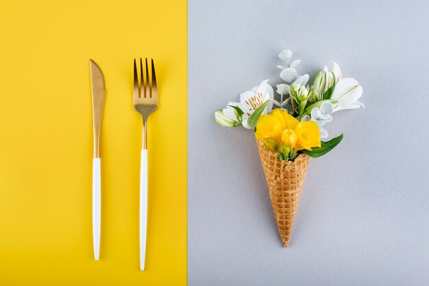 Eco ice cream cone with flowers and cutlery