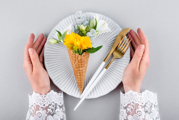 Eco ice cream cone with flowers above view