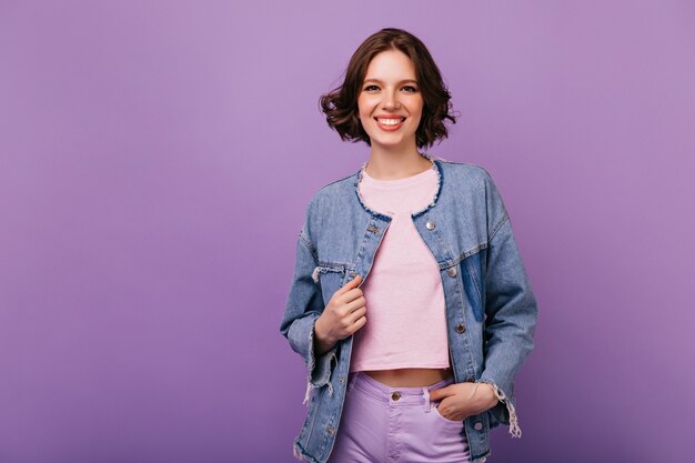 Ecstatic emotional woman laughing. Winsome caucasian girl in denim jacket smiling.