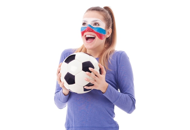 Ecstatic female fan with soccer ball cheering