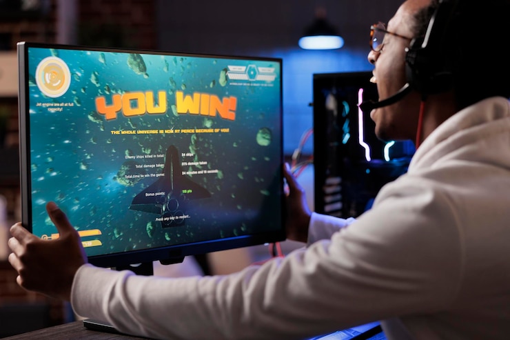 Free Photo ecstatic gamer playing intense classic arcade spaceship racing videogame, shaking computer display and yelling after winning. african american man having burst of happiness after game victory