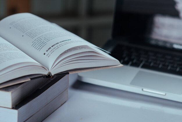 education concept,  books and laptop at library