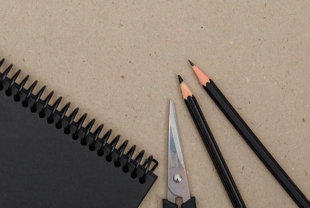 Free photo education concept with pencils, scissors, notebook on paper.