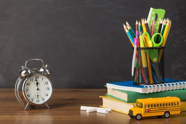 Education day arrangement on a table with a clock