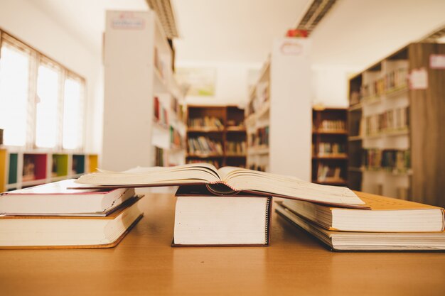 education learning concept with opening book or textbook in old library
