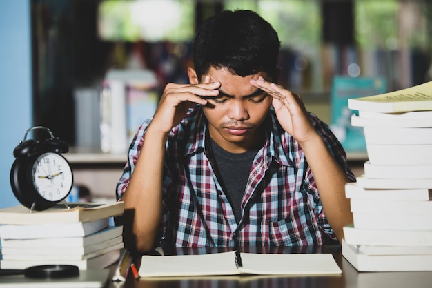 Educational conept: tired student in a library Free Photo