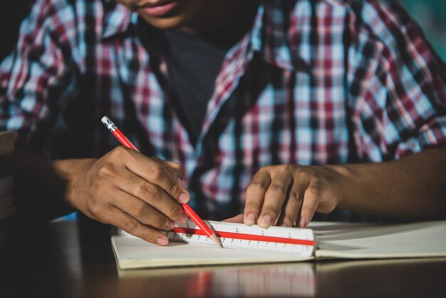 Educational theme: Close -up Student writing in a classroom.