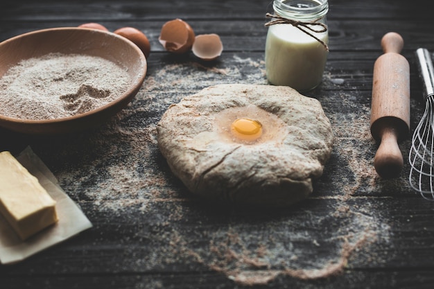 Free photo egg beaten into bread dough