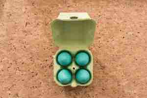 Free photo egg box with four easter eggs