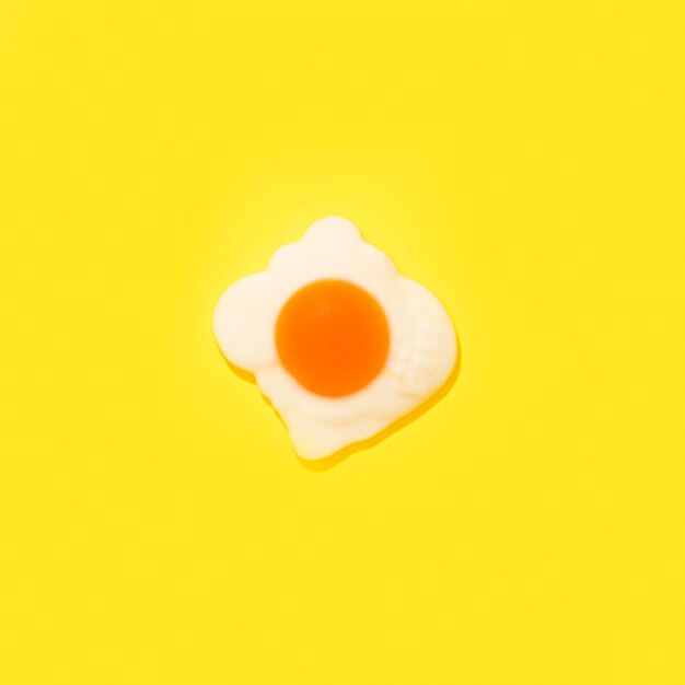 Egg candy on yellow background