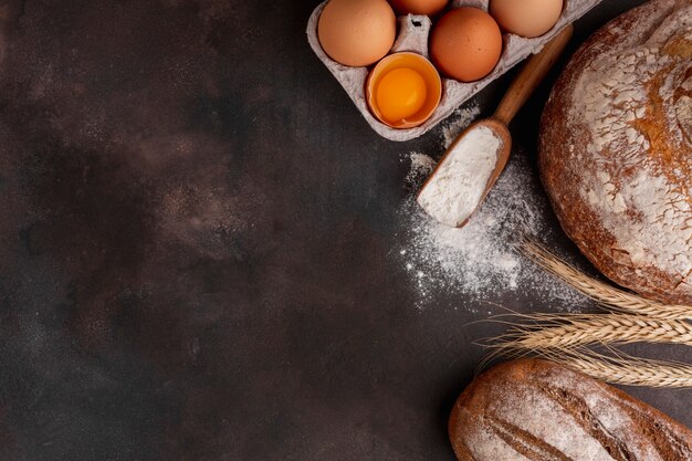 Egg carton and wooden spoon with flour