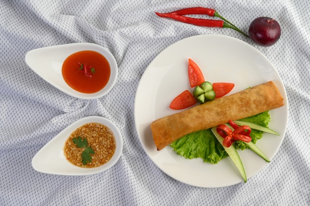 Egg roll or Fried Spring Rolls on the white plate Thai food. Top view.