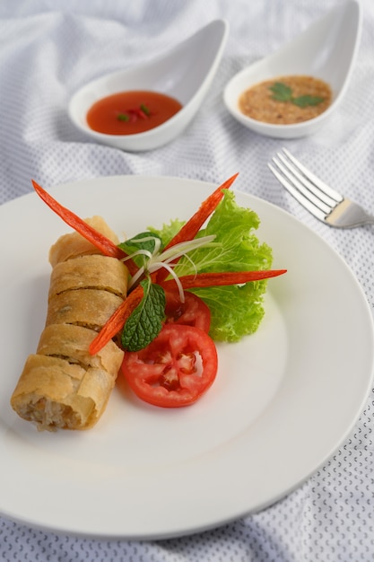 Free photo egg roll or fried spring rolls on the white plate thai food. .