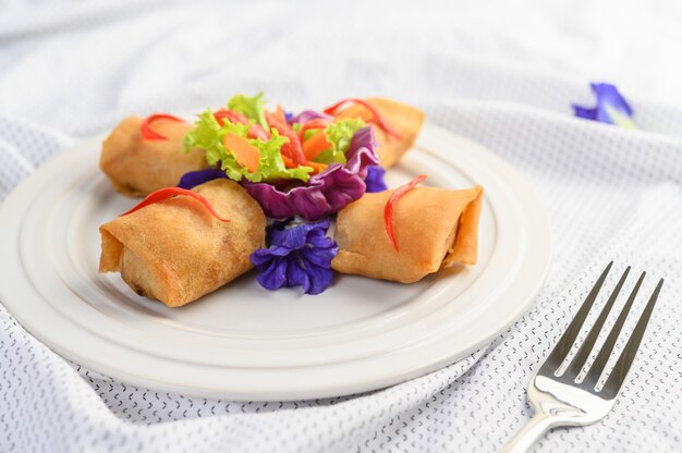 Egg roll or Fried Spring Rolls on the white plate Thai food. .