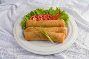 egg roll or fried spring rolls on the white plate thai food. .