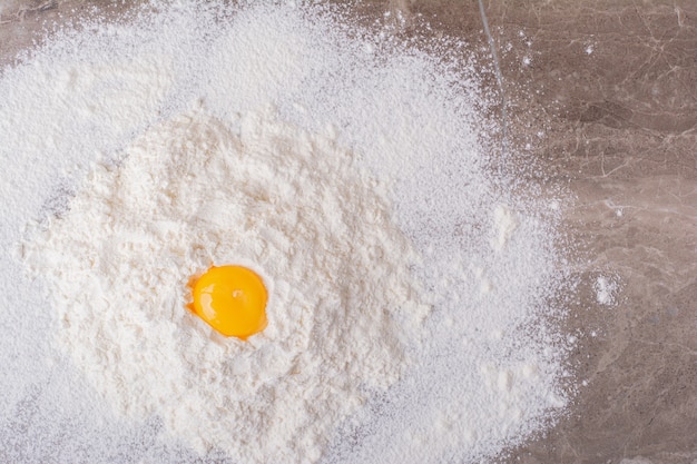 An egg yolk on the flour to make dough