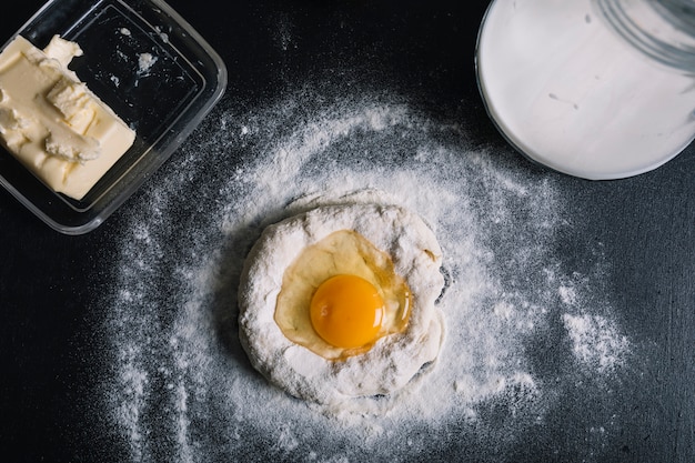 Egg york over the dough on kitchen counter