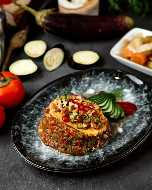 Eggplant caviar topped with herbs and pomegranate