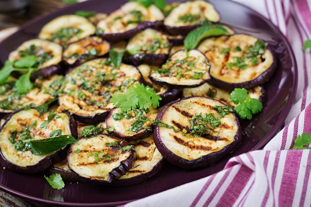 Eggplant grilled with balsamic sauce, garlic, cilantro and mint. Vegan food. Grilled aubergine.