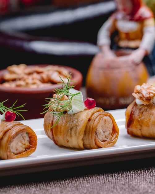 Eggplant roll walnuts onion garlic cream cheese pomegranate dill side view