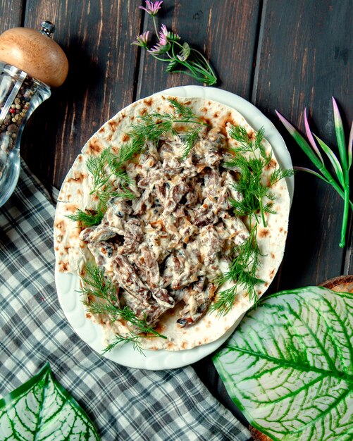 Eggplant salad under sauce on the table