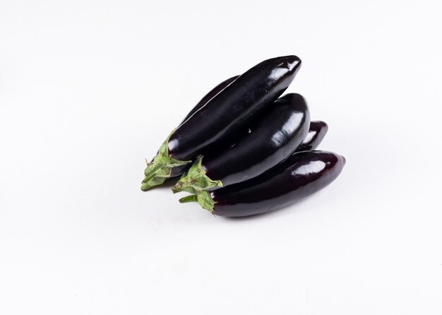 Eggplants one on another high angle view on a white 