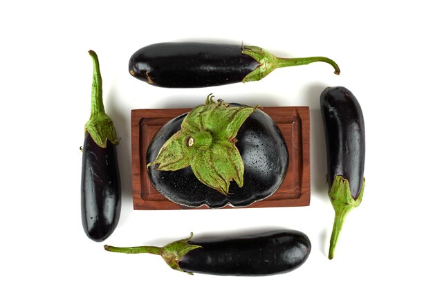 Eggplants on a wooden platter.