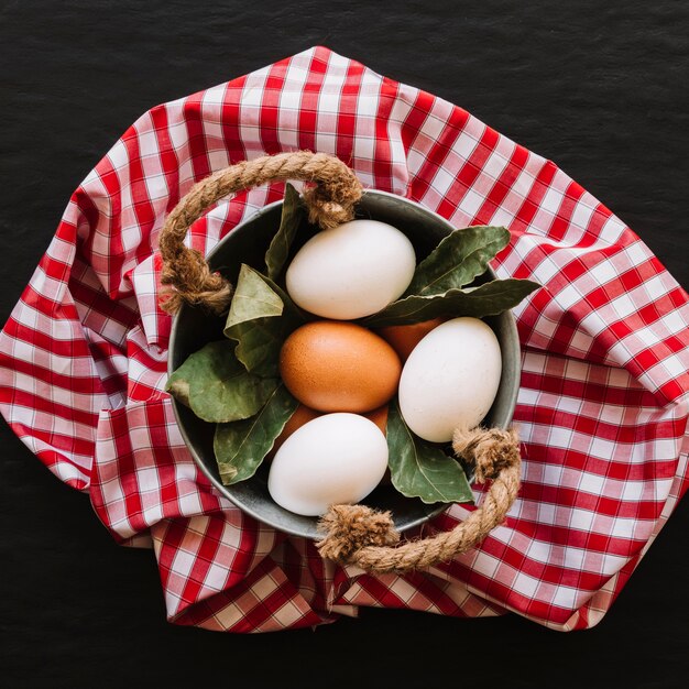 Eggs and bay leaves in saucepan