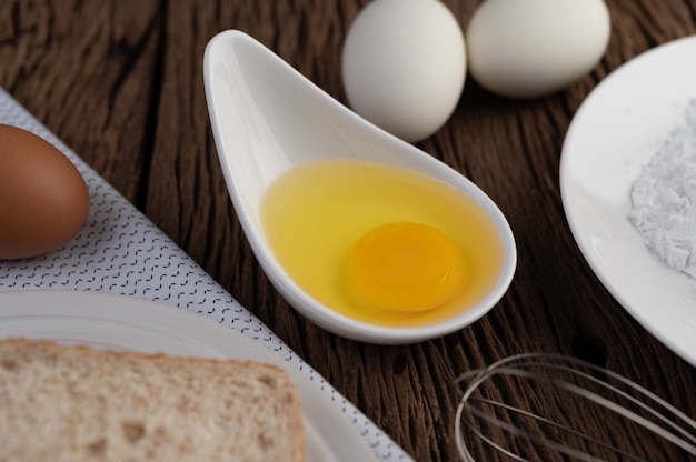Eggs, bread, tapioca flour and an egg beater, ingredients used in bakery