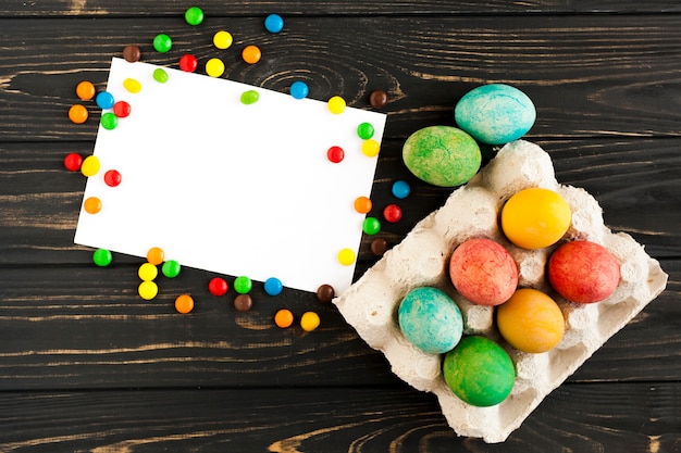 Free photo eggs and candies near paper